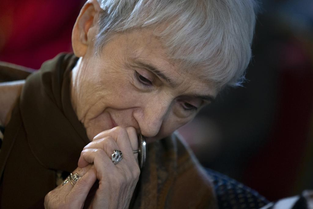 A woman listens to Holocaust survivor Mikhail Spectr in Moscow
