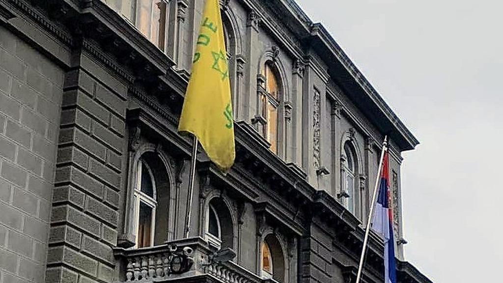 The official Serbian Presidential Residence in Belgrade flying the yellow flag alongside the national flag 