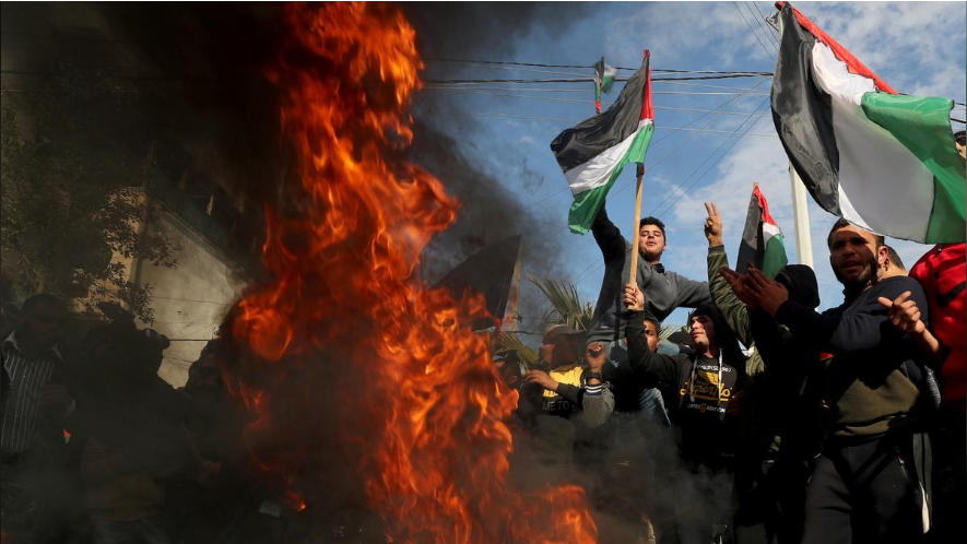 Palestinians in Gaza City protest as tires burn ahead of the announcement by U.S. President Donald Trump of his Mideast peace plan 