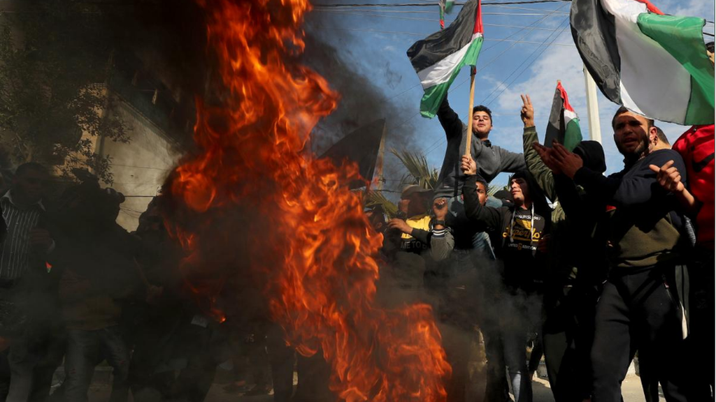 Palestinians in Gaza City protest as tires burn ahead of the announcement by U.S. President Donald Trump of his Mideast peace plan 