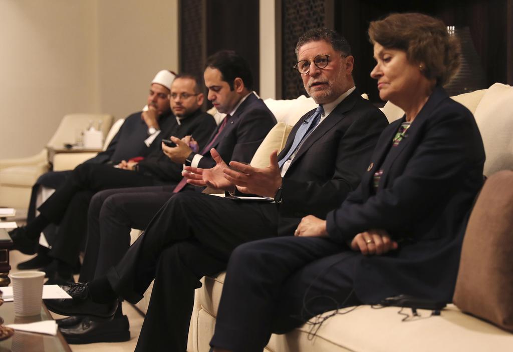 Bruce Lustig, second right, speaks to journalists at interfaith conference in Abu Dhabi