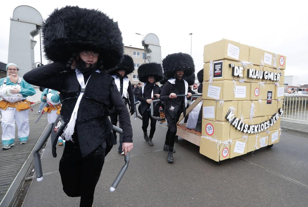 People dress as caricatures of Orthdox Jews with a mock Western Wall at the parade in Aalst, Feb. 23 2020 