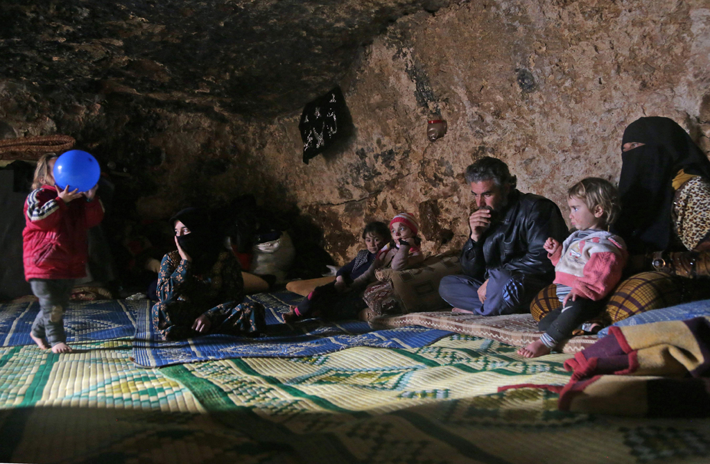 Syrian refugees in Idlib hiding from the fighting in an underground cave 