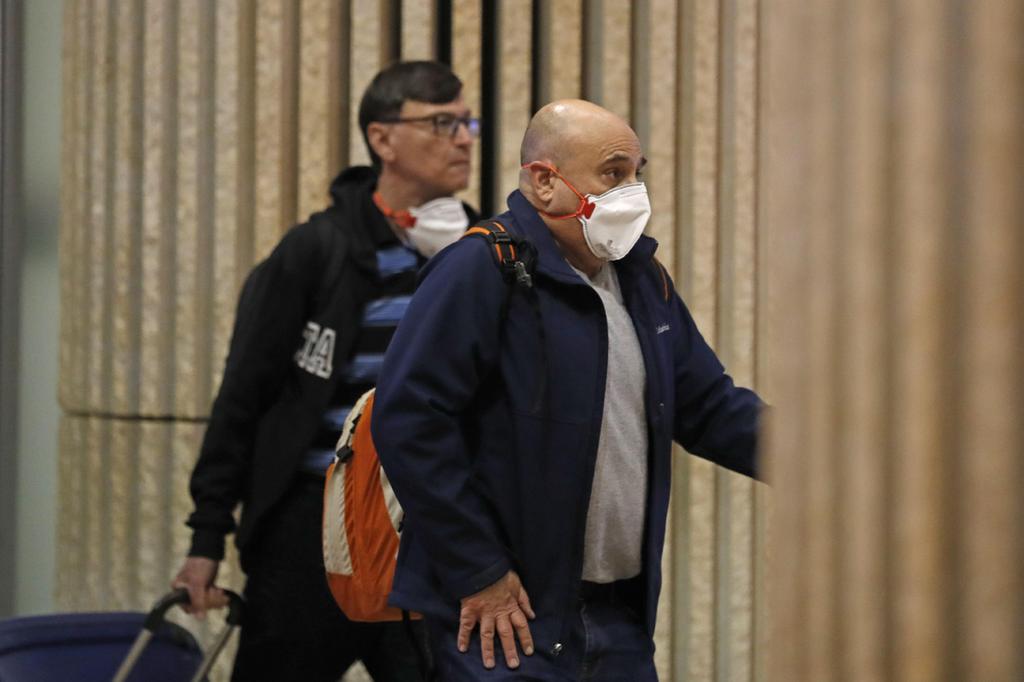  Travelers wearing masks against coronavirus arrive at Ben-Gurion Airport 