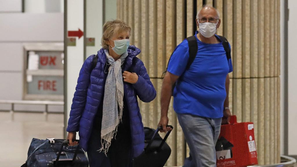 Travelers wearing masks against coronavirus arrive at Ben-Gurion Airport 
