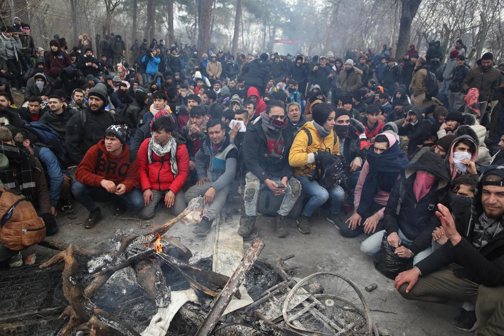 Syrian refugees rest before attempting to cross the border from Turkey into Greece, Feb. 29 2020 