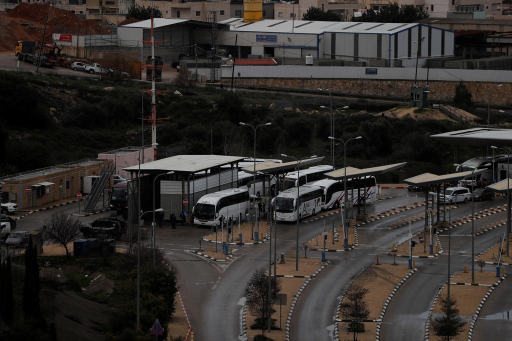 Tourist busses wait at an Israeli checkpoint