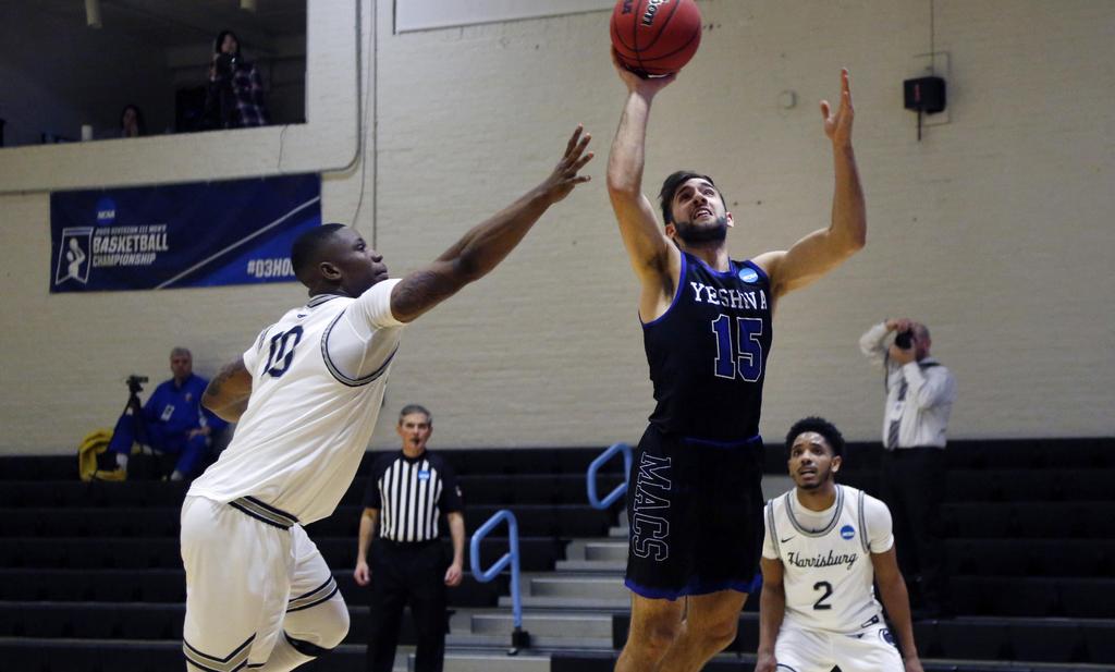 Yeshiva guard Eitan Halpert (15) jumps for a layup against Penn State-Harrisburg in an NCAA men's Division III college basketball tournament game