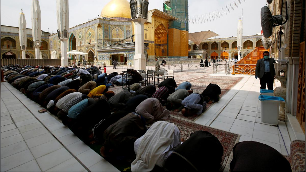 Shi'ite Muslim pilgrims pray at Imam Ali Shrine after Iraq's Najaf authorities banned all non-residents visits 