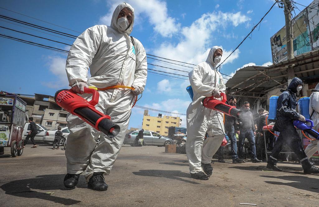 Sanitation workers disinfect the streets of Gaza 