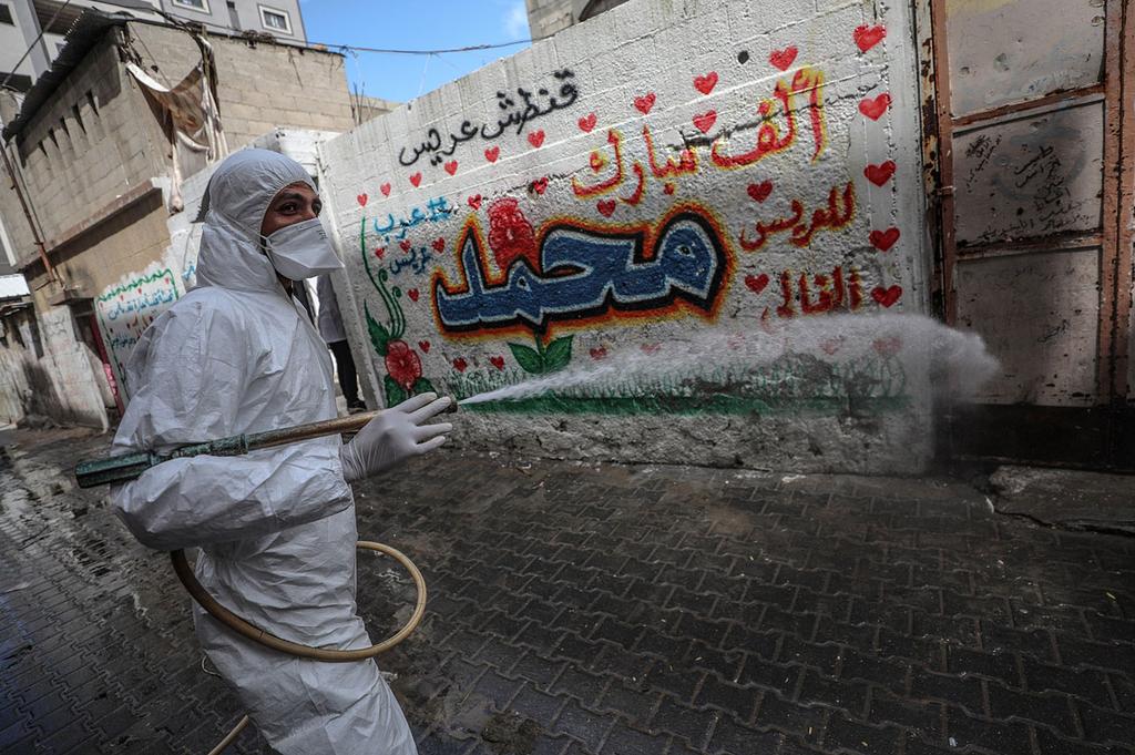 Gaza health worker spraying disinfectant in the streets amid coronavirus outbreak 