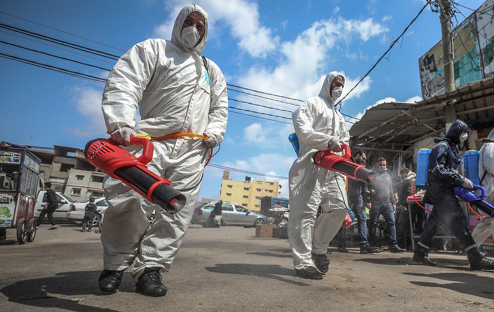 Health workers disinfect the streets in the Gaza Strip 