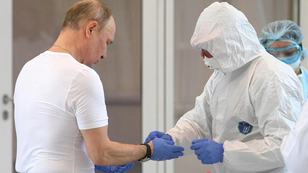 Russian President Vladimir Putin before putting on a hazmat suit during a visit to a coronavirus hospital in Moscow 
