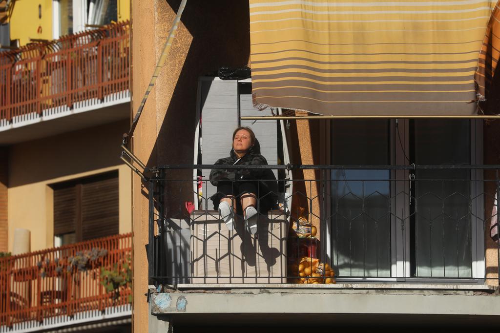 A woman sits on her balcony in Rome during the Italian lockdown 