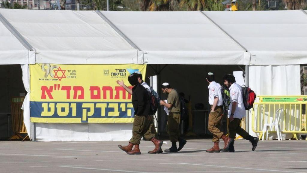 חיילים עוזרים לצוות מד"א במתחם "היבדק וסע" בתל אביב