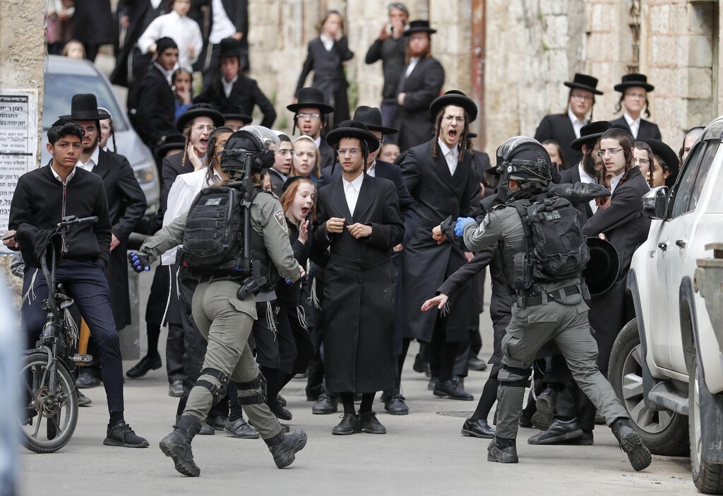 Israeli security forces arrest an Ultra-Orthodox Jewish man as they close a synagogue in the Mea Shearim Ultra-Orthodox neighbourhood in Jerusalem 