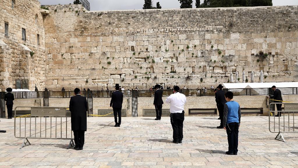 Jewish worshippers practice social distancing at the Western Wall in Jerusalem, March 31, 2020 