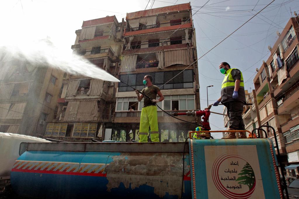 Lebanese sanitation workers spraying disinfectant during coronavirus outbreak 