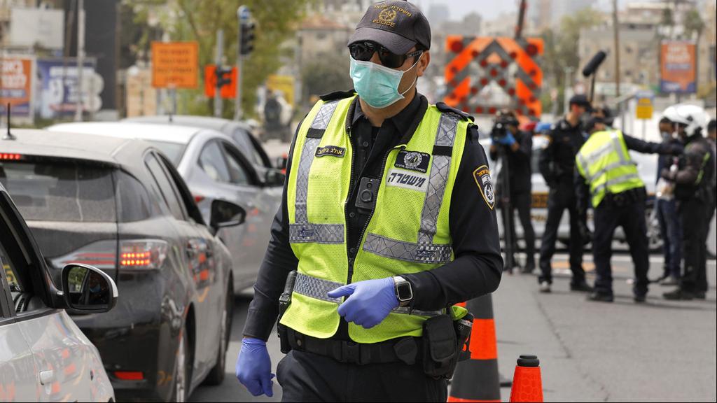  Police officer with a surgical mask in Bnei Brak 