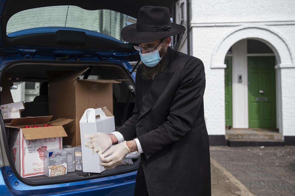 Rabbi Mechel Gancz of from Finchley Chabad in Lodon prepares 'Seder to go' boxes for delivery ahead of the first night of Passover, April 8, 2020 