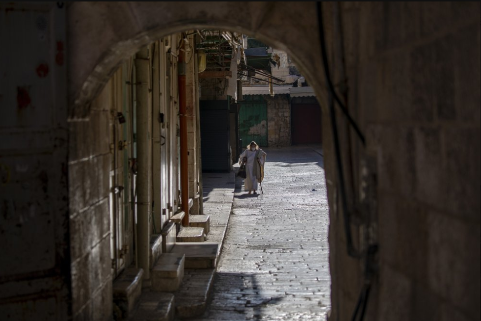 A worshiper walks towards the Church of the Holy Sepulchre in Jerusalem 