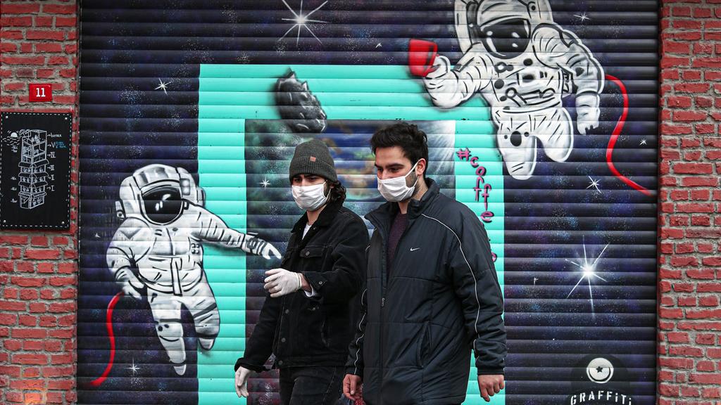  People wearing masks walk in Istanbul during the coronavirus crisis 