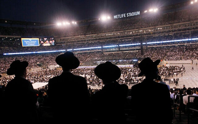 A large crowd of Orthodox Jewish men stand at MetLife stadium in East Rutherford, New Jersey, during the celebration of Siyum HaShas 