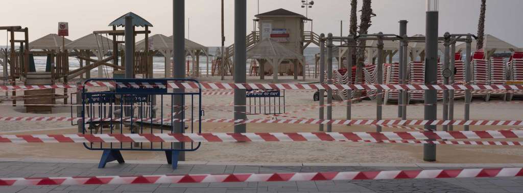Tel Aviv's beachfront wrapped in tape to prevent public access during a lockdown 