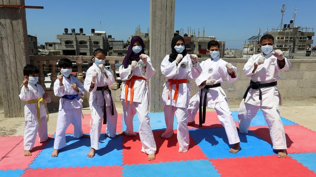 Sheikheleid family members train in their makeshift rooftop karate club in the Rafah Governorate of the Gaza Strip 