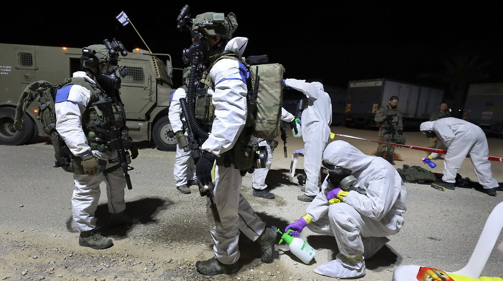 Police anti-terror unit disinfect themselves and their gear ahead of their mission in the West Bank 