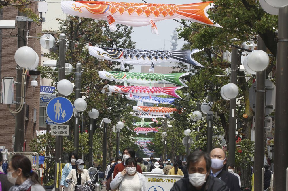 People wearing face masks to protect against the spread of the new coronavirus walk around open public areas in Yokohama near Tokyo 