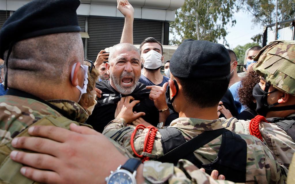 Anti-government protesters scuffle with Lebanese army soldiers in the town of Zouk Mosbeh, north of Beirut 