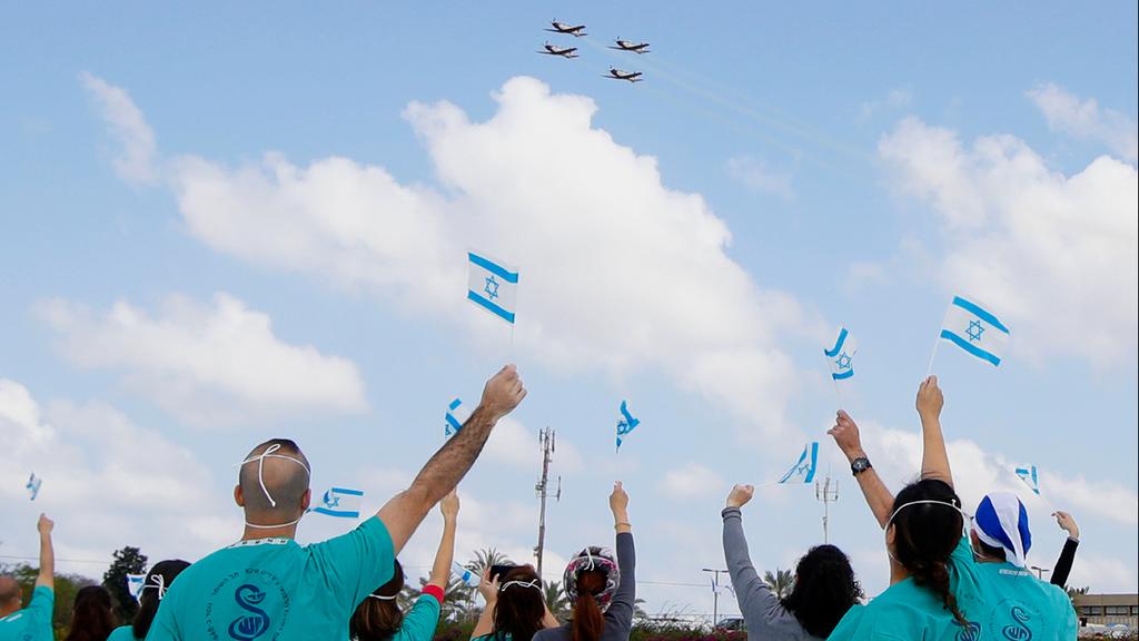  Medical teams wave at a flyby in their honor outside the Sheba Medical Center near Tel Aviv 