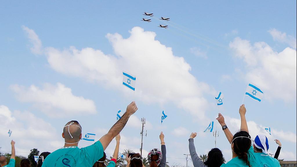  Medical teams at the Shiba Medical Center cheer as the Airforce flies by in salute of health workers 