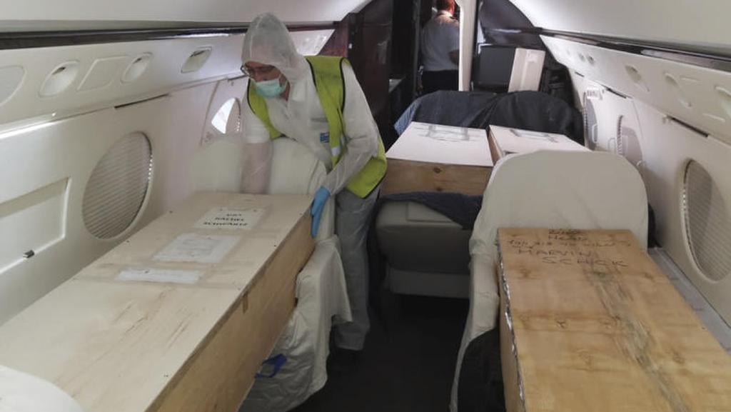 ZAKA voluntary emergency team, a member unloads a coffin from a plane at Ben Gurion airport in Israel 