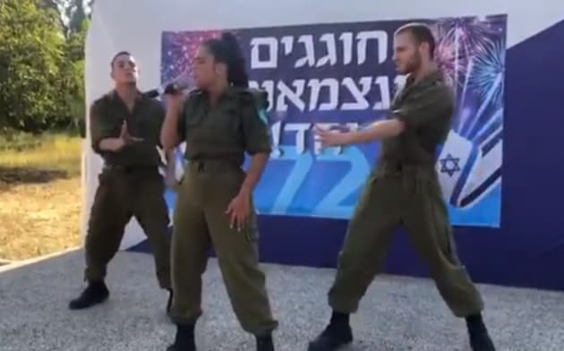 Noa Kirel and two military dancers 