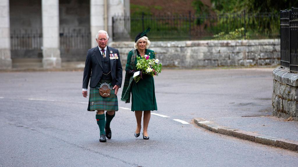 Britain's Charles, Prince of Wales and Camilla, Duchess of Cornwall walk to take part in a two-minute silence to mark the 75th anniversary of VE Day at the Balmoral War Memorial, Scotland