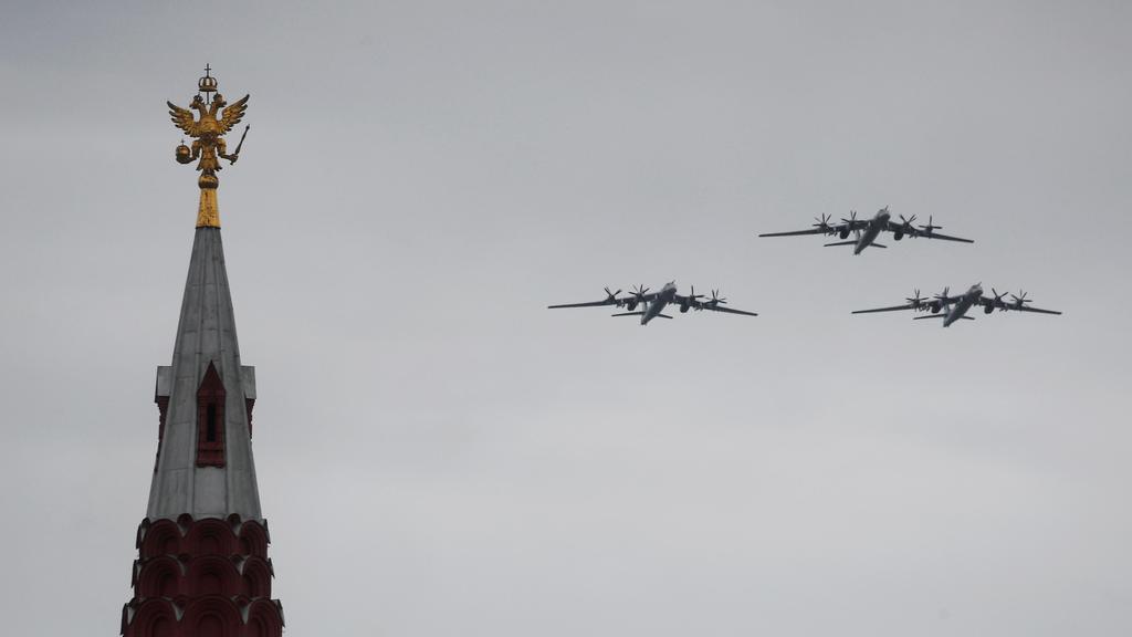 Tu-95MS strategic bombers fly in formation above the State Historical Museum during an air parade on Victory Day 