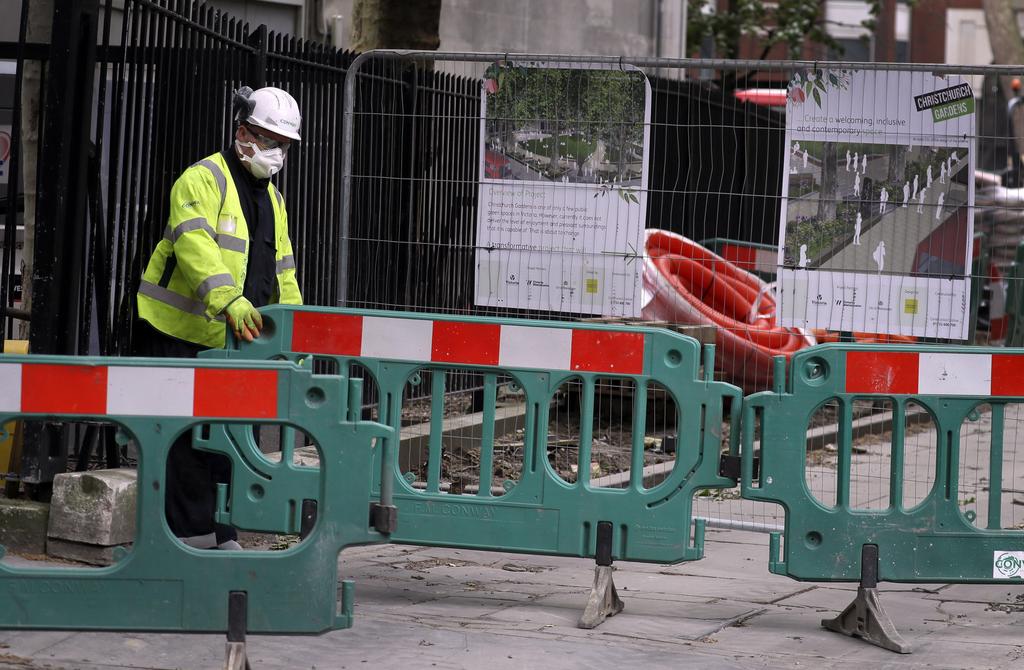A construction worker wears protective equiment as he works in London as the country is in lockdown to help stop the spread of coronavirus 