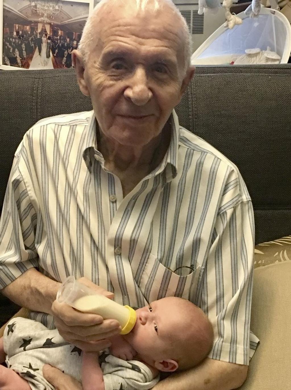 Alexander Feingold holds his first grandchild Dylan at his home in New York 