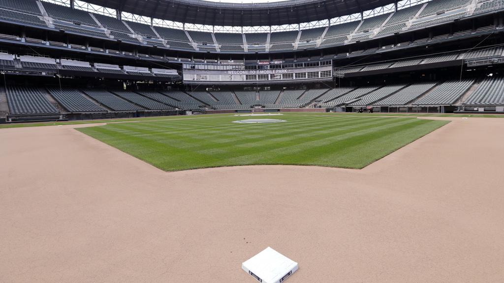 Second base sits in its place in an otherwise empty ballpark where grounds crew members continue to keep the Seattle Mariners' field 