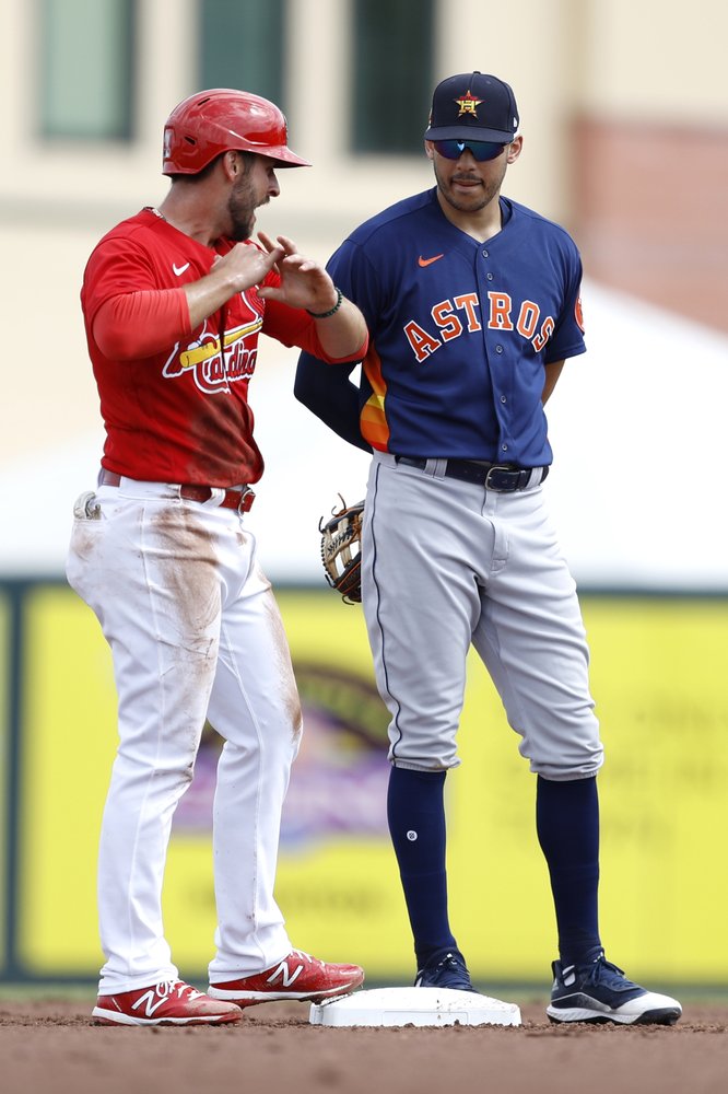St. Louis Cardinals' Paul DeJong, left, talks to Houston Astros shortstop Carlos Correa during the second inning of a spring training baseball game in Jupiter, Fla. 