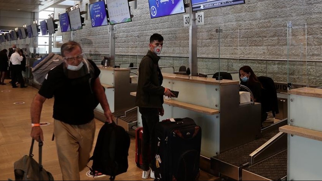  Passengers and staff wear masks at Ben-Gurion International Airport, Israel's primary port of entry