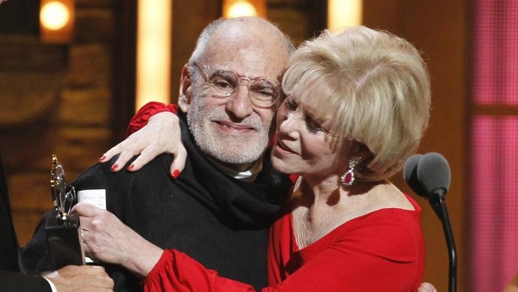 Larry Kramer, left, and Daryl Roth embracing after they won the Tony Award for Best Revival of a Play for "The Normal Heart" during the 65th annual Tony Awards in New York 