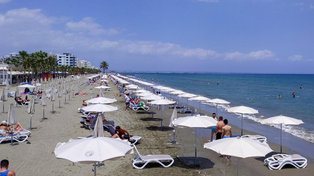 People gather at Mackenzie beach in the coastal city of Larnaca on the Mediterranean island of Cyprus