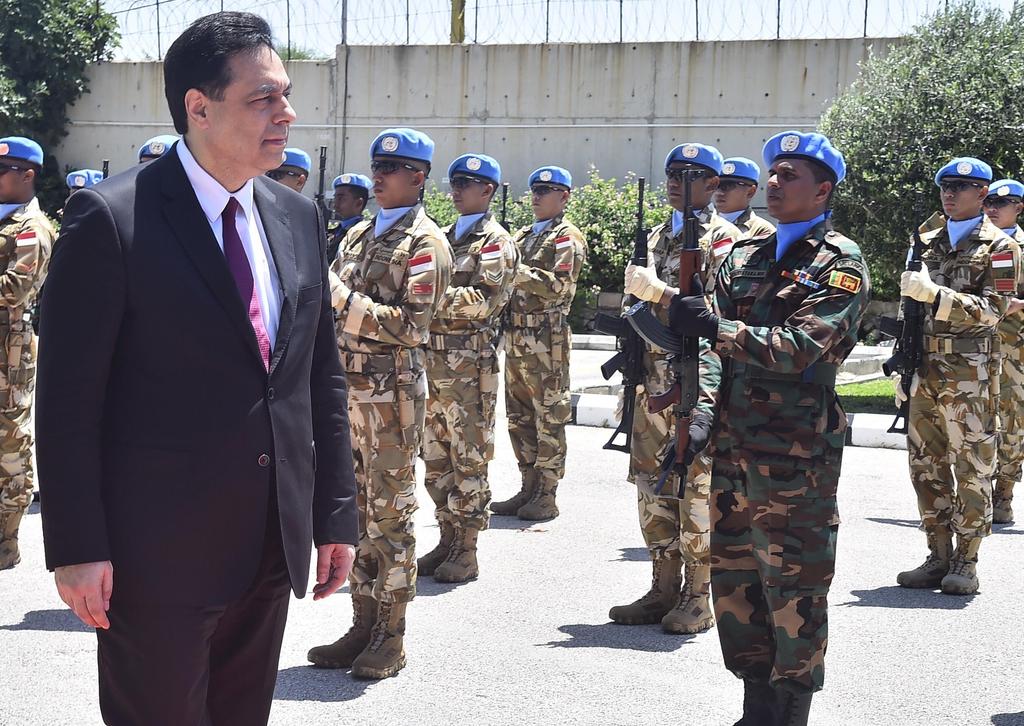 Lebanese Prime Minister Hassan Diab reviews the honor guard of the United Nations peacekeepers, upon his arrival at their headquarters in the southern coastal border town of Naqoura 