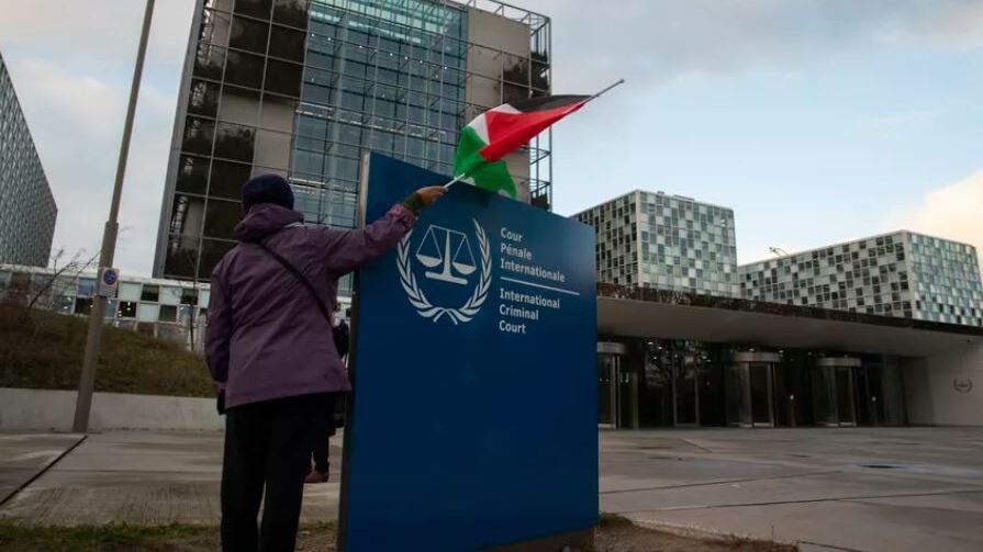 A demonstrator poses with a Palestinian flag outside the International Criminal Court (Photo: AP) A demonstrator poses with a Palestinian flag outside the International Criminal Court
