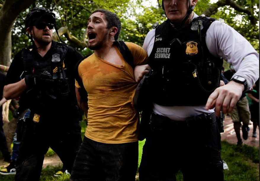 A protestor yells as he is being detained by the Secret Service outisde the White House in Washington 