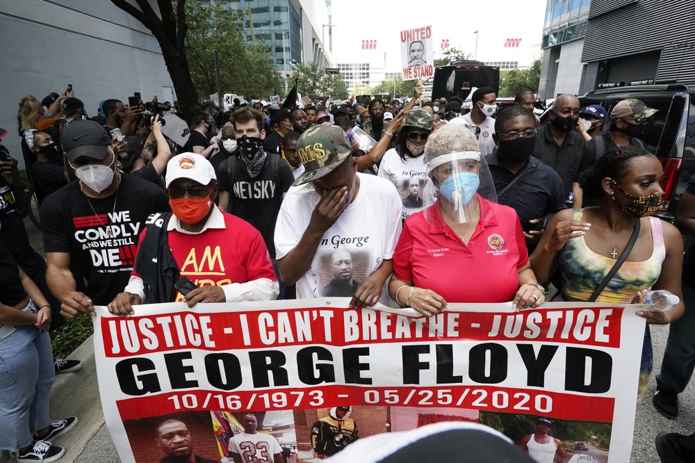 LaTonya Floyd, third from left, participates in a march to protest the death of her brother, George Floyd in Houston 