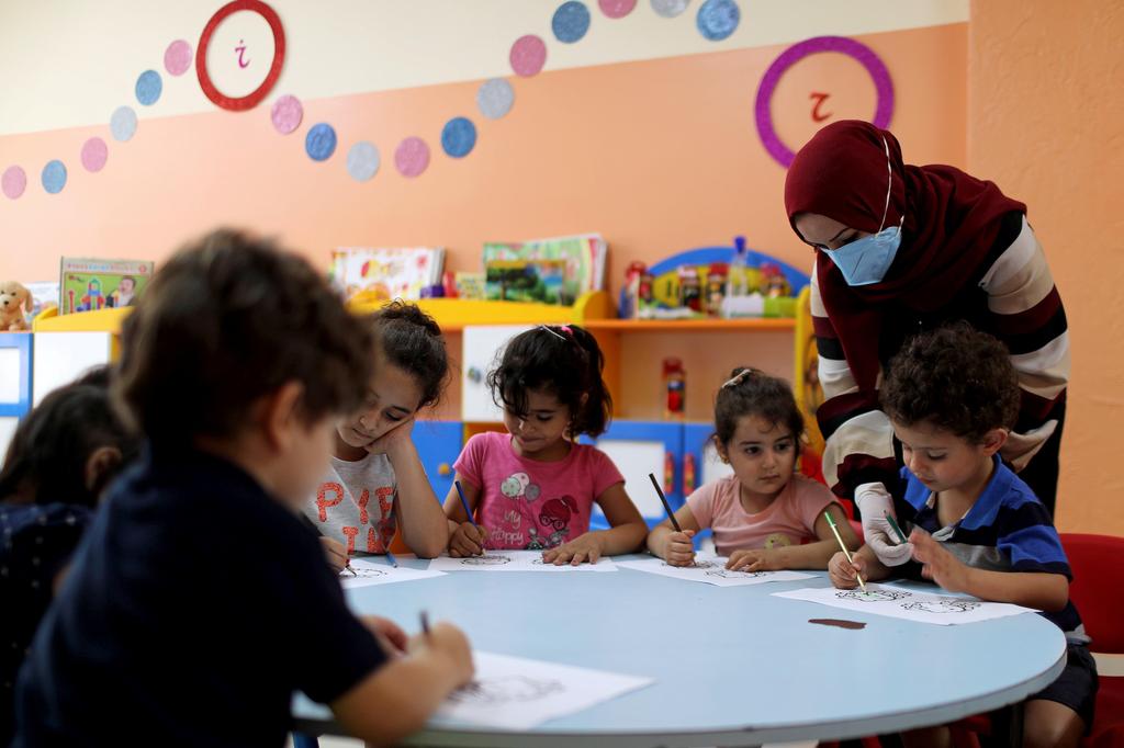 Children attend a drawing activity in a nursery school in Gaza City 